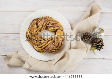 Kringle or pretzel, traditional Christmas dessert in Northen Europe with cinnamon and walnuts