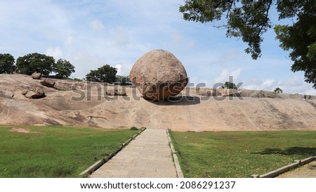 Krishna Butter Ball Large rock and blue sky. A balance rock. Located in the natural background.