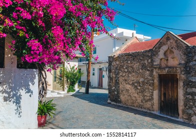 Kritsa traditional cretan village with stone built church, narrow alley and houses with bougainvilleas, near Agios Nikolaos. Crete, Greece  - Shutterstock ID 1552814117