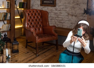 Krivoy Rog. Ukraine. November 2020. Woman Puts An IPhone 12 On A Tripod, On A Christmas Background