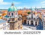 Krizovnicke Square in Prague, Czechia. The Church of Saint Francis of Assisi dominates the foreground, with its distinctive green dome and towering facade. The Church of Saint Salvator sits to the