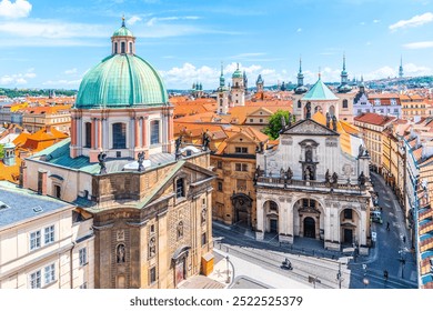 Krizovnicke Square in Prague, Czechia. The Church of Saint Francis of Assisi dominates the foreground, with its distinctive green dome and towering facade. The Church of Saint Salvator sits to the - Powered by Shutterstock