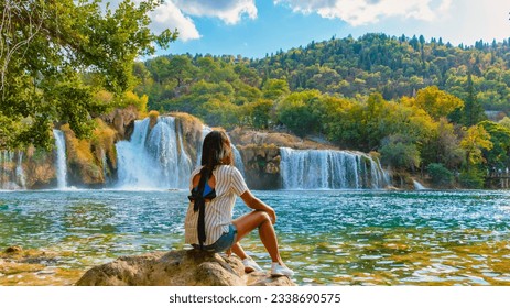 KRKA waterfalls Croatia during summer, young Asian women watch the waterfalls of krka national park Croatia on a bright summer evening in the park. - Powered by Shutterstock