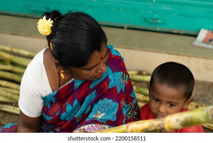 K.R.Market,Bengaluru, India -14-08-2022:Top View Of Mother Looking At His Kid. Indian Mother With Flowers And Saree And Kumkuma