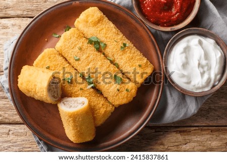 Krokiety is a traditional Polish side dish consisting of crepes filled with meat, then breaded and fried closeup on the plate on the wooden table. Horizontal top view from above
 Zdjęcia stock © 