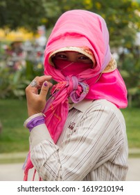 Krong Siem Reap, Cambodia - 2/27/2011:  Portrait Of A Woman Construction Worker Who Was Mixing Cement Grout For A Brick Wall.  The Face Covering Is To Protect Her Fair Skin From The Hot Sun.