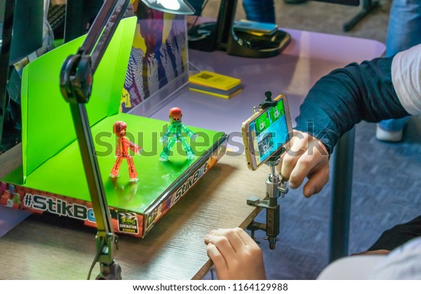 KROPIVNITSKIY, UKRAINE – 12\
MAY, 2018: Stop motion animation process with Stikbot details and\
toy figures. Boy expose stop motion elements to create animations\
using smartphone