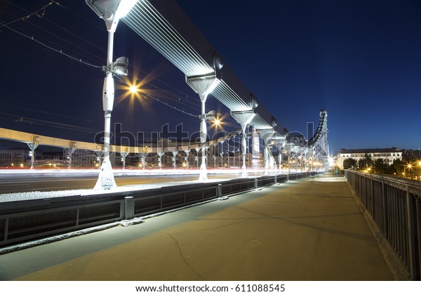 Krymsky Bridge or Crimean\
Bridge (night) is a steel suspension bridge in Moscow, Russia. The\
bridge spans the Moskva River 1,800 metres south-west from the\
Kremlin