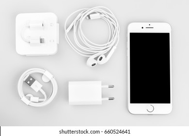 KRYNICA ZDROJ, POLAND - JUNE 13, 2017: Iphone 7  silver serie , Apple inc new smartphone with charger, earphones and adapter on white background.