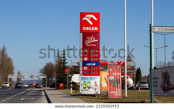 KRZESZOWICE, POLAND - MARCH 21,\
2022: Orlen and Stop Cafe Bistro sign outside a petrol station.\
Logo at filling gas station forecourt with prices displayed on a\
pylon.