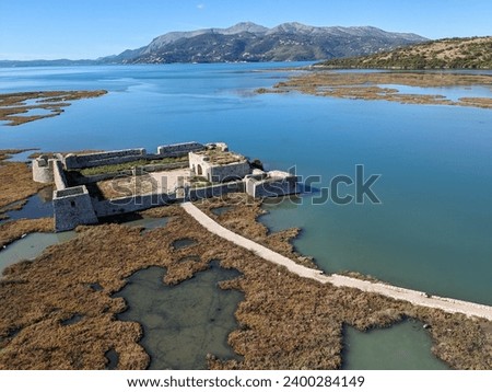 Ksamil, Albania A view of the Ali Pasha Ottoman castle at the inlet of Lake Butrint.Aerial panorama landscape view of island with castle in Saranda region
