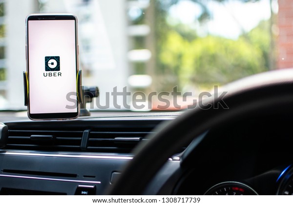 KUALA LUMPUR: 10 FEB 2019 -  Car driver\
using smartphone with with Uber app on screen.\
