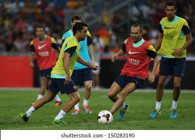 KUALA LUMPUR - AUGUST 09: FC Barcelona 's Xavi Hernandez (yellow) Takes On Andres Iniesta (red) During Training At The Bukit Jalil Stadium On August 09, 2013 In Malaysia. 