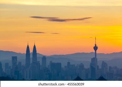 Kuala Lumpur cityscape at dawn, clear orange sky with minimal clouds - Powered by Shutterstock