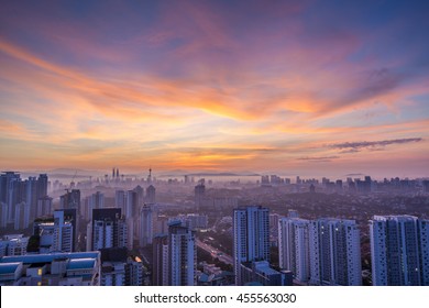 Kuala Lumpur cityscape at dawn with colorful cloudy sky, viewed from Mont Kiara, east of KL - Powered by Shutterstock