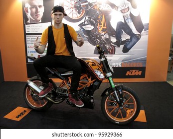 KUALA LUMPUR - FEB 23: Rok Bagoros, KTM 125 Duke Stunt Rider Poses With The Bike During MotoXpo Show & Conference On Feb 23, 2012 At The Putra World Trade Centre (PWTC) In Kuala Lumpur, Malaysia