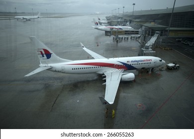 KUALA LUMPUR INTERNATIONAL AIRPORT (KLIA), SEPANG, MALAYSIA - AUGUST 08 :Malaysia Airlines plane on a wet tarmac at Kuala Lumpur International Airport (KLIA) in Sepang, Malaysia.