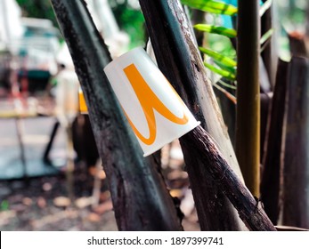 Kuala Lumpur, Malaysia - 18 January,2021: Recycled Mc Donalds Paper Cup Left On The Tree, Noise And Grain Effects.