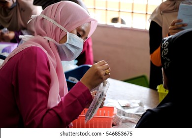 Kuala Lumpur, Malaysia - 1st January 2017 : A female doctor is giving her patient medicine