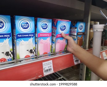 Kuala Lumpur, Malaysia, 20 April 2021: A Needy Kid Taking A Milk From The Fridge Rack For Her Needs. 