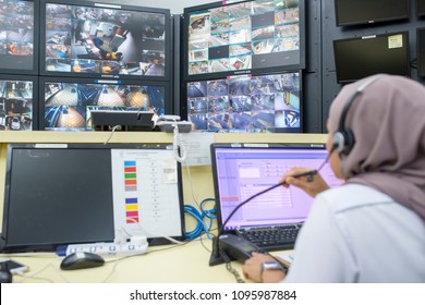 Kuala Lumpur, Malaysia, 21 May 2018 :  Car going in to super ramp car parking with monitor by security control room operator - Shutterstock ID 1095987884
