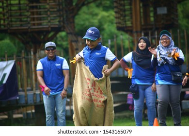 Kuala Lumpur, Malaysia - 28 October, 2019: Company Family Day. Adult And Kids Enjoy Playing With Gunny Sack Named Gunny Sack Race Sport.