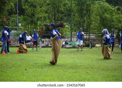 Kuala Lumpur, Malaysia - 28 October, 2019: Company Family Day. Adult And Kids Enjoy Playing With Gunny Sack Named Gunny Sack Race Sport.