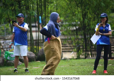 Kuala Lumpur, Malaysia - 28 October, 2019: Company Family Day. Adult And Kids Enjoy Playing With Gunny Sack Named Gunny Sack Race Sport.