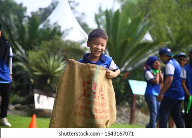 Kuala Lumpur, Malaysia - 28 October, 2019: Company Family Day. Adult And Kids Enjoy Playing With Gunny Sack Named Gunny Sack Race Sport.