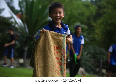 Kuala Lumpur, Malaysia - 28 October, 2019: Company Family Day. Adult And Kids Enjoy Playing With Gunny Sack Named Gunny Sack Race Sport.