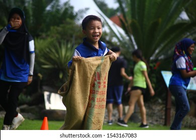 Kuala Lumpur, Malaysia - 28 October, 2019: Company Family Day. Adult And Kids Enjoy Playing With Gunny Sack Named Gunny Sack Race Sport.