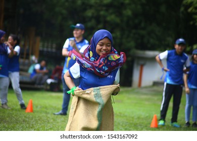 Kuala Lumpur, Malaysia - 28 October, 2019: Company Family Day. Adult And Kids Enjoy Playing With Gunny Sack Named Gunny Sack Race Sport.