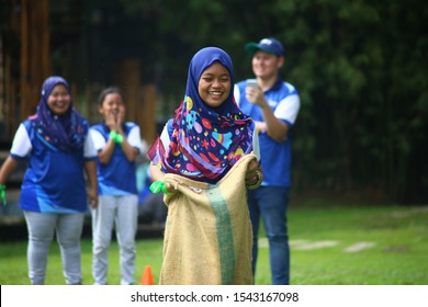 Kuala Lumpur, Malaysia - 28 October, 2019: Company Family Day. Adult And Kids Enjoy Playing With Gunny Sack Named Gunny Sack Race Sport.