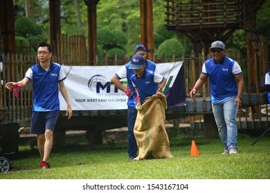 Kuala Lumpur, Malaysia - 28 October, 2019: Company Family Day. Adult And Kids Enjoy Playing With Gunny Sack Named Gunny Sack Race Sport.