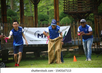 Kuala Lumpur, Malaysia - 28 October, 2019: Company Family Day. Adult And Kids Enjoy Playing With Gunny Sack Named Gunny Sack Race Sport.