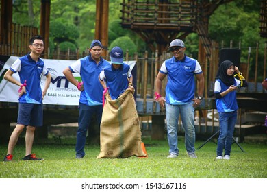 Kuala Lumpur, Malaysia - 28 October, 2019: Company Family Day. Adult And Kids Enjoy Playing With Gunny Sack Named Gunny Sack Race Sport.