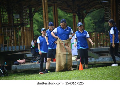 Kuala Lumpur, Malaysia - 28 October, 2019: Company Family Day. Adult And Kids Enjoy Playing With Gunny Sack Named Gunny Sack Race Sport.