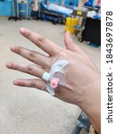 Kuala Lumpur, Malaysia - 30 Oktober 2020: Woman hand with IV saline intravenous on hand in hospital white background.