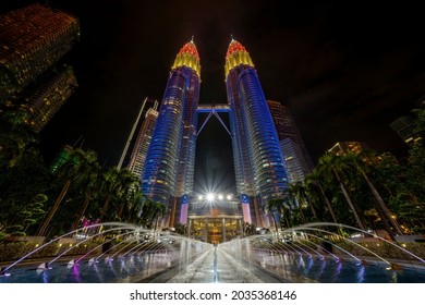 Kuala Lumpur, MALAYSIA - 31 August 2021: Petronas Twin Towers (known as KLCC) displaying the colors of the Malaysian flag, which are red, yellow and blue during the 64th National Day celebration.