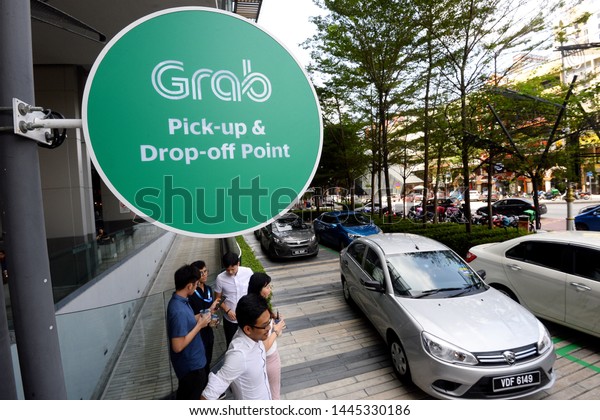 Kuala Lumpur, Malaysia - 6 June2019 :

Passenger taking a grab car service at grab car pick-up and
drop-off point at a shopping mall in Kuala
Lumpur.