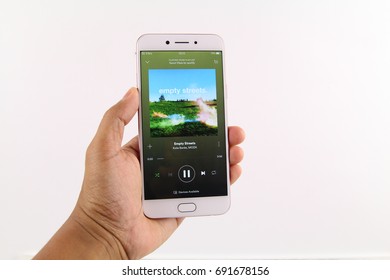 KUALA LUMPUR, MALAYSIA - 6th August 2017: A Smart Phone With Spotify Application On The Screen Over Wooden Texture Background. Spotify Is A Music, Podcast, And Video Streaming Service.