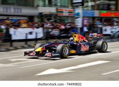 KUALA LUMPUR, MALAYSIA - APR 3 : Former Red Bull F1 driver David Coulthard of Britain steers his car during a street demonstration on April 3, 2011 in downtown Kuala Lumpur, Malaysia.