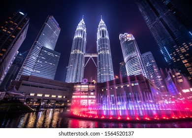 Kuala Lumpur, Malaysia. April 28, 2018: Night view of Petronas Twin Towers KLCC and Symphony Lake, the most attractive place in Malaysia. Beautiful multi colored musical fountains.