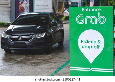 KUALA LUMPUR, MALAYSIA - AUGUST 03, 2022: An E-hailing Company Logo, Grab Car Display Stand For Pick-up And Drop-off Passengers.