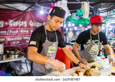 Kuala Lumpur, Malaysia - August 15 2019: Local Night Market Worker Selling Coconut Rice Or Known As 