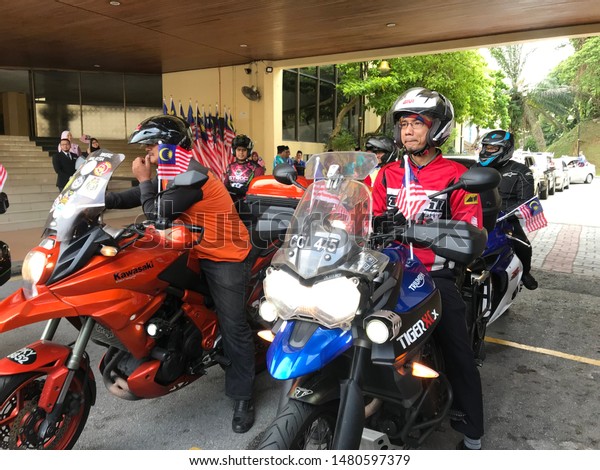 Kuala\
Lumpur, Malaysia - August 16th, 2019 : Group of bikers flying\
Malaysian flag before starting convoy ride around downtown of Kuala\
Lumpur. Celebrating Malaysia Independence\
day.