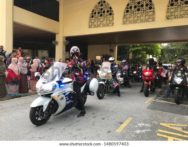 Kuala\
Lumpur, Malaysia - August 16th, 2019 : Group of bikers flying\
Malaysian flag before starting convoy ride around downtown of Kuala\
Lumpur. Celebrating Malaysia Independence\
day.