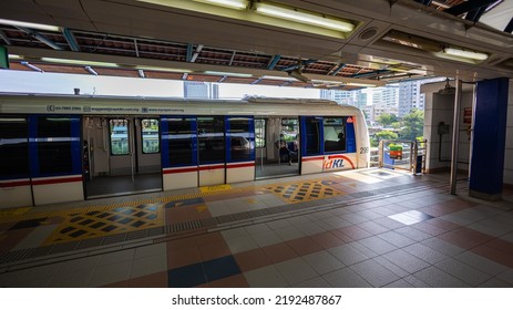 Kuala Lumpur, Malaysia - August 21, 2022: Train Of The Rapid KL Public Transport System At The Platform Of The Asian Jaya Train Station. Railroad Tracks Meander Through The City Above The Streets