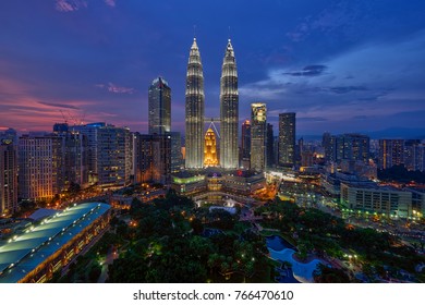 Kuala Lumpur, MALAYSIA - circa August 2017: Petronas Twin Towers (fondly known as KLCC) and the surrounding buildings at sunset seen from the Skybar at Traders Hotel.