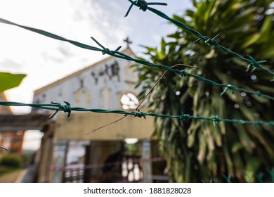 Kuala Lumpur, Malaysia - December 24, 2020: the ruin of a church behind barbed wire. The dilapidated building is about to collapse. The christian community in malaysia is in the minority